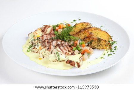 Fried potatoes with meat and grilled vegetables laid out on a plate and isolated