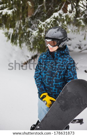 girl holding a snowboard standing in the woods, that would free ride