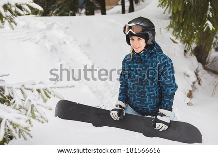 sexy girl standing and holding a snowboard