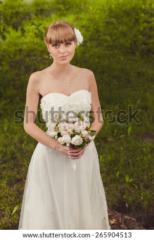 Wedding: Portrait of beautiful bride in garden.