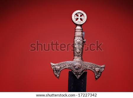 Thomas Salek Stock-photo-detailed-medieval-sword-hilt-on-red-17227342