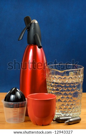 A set for cooking of soda water. Siphon, cup, jug with water, juice, cartridges with gas.
