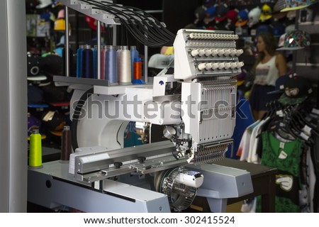 Embroidery machine with spools of color threads