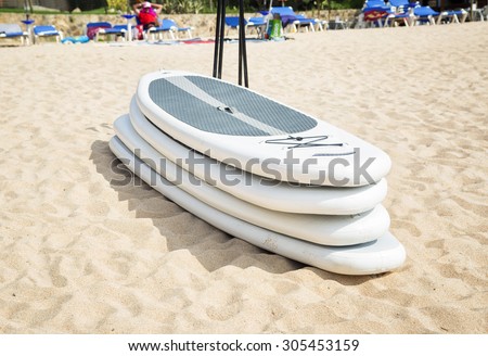 White plastic surfboards on a sand
