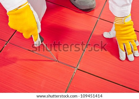 Sharp tool clean spaces between tiles remove tile adhesive debris
