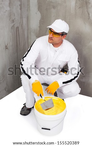 Worker mixing a plaster with a trowel