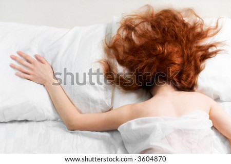Sleeping lonely red-haired woman (soft-focused)