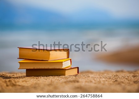 Closed books on a beach