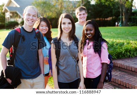 Diverse group of friends walking and smiling