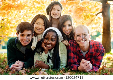 Diverse Group Of Smiling Friends In A Pyramid In Autumn