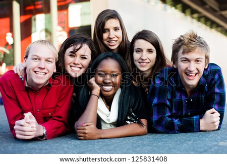 Group of diverse students outside in a pyramid