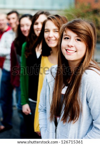 Group of students outside smiling in a line together