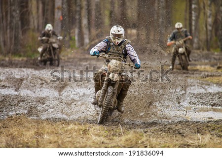 Motocross driver on wet and muddy terrain in Finland.