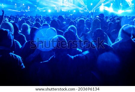 Heavy metal concert audience enjoying music in the rain.