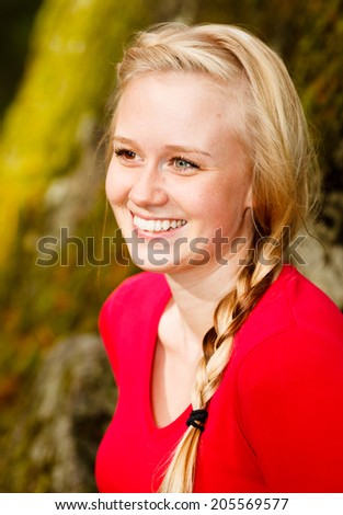 Hiker woman smiling natural candid in happy outdoor portrait. Aspirational lifestyle image of hiking young female hiker in Finland.