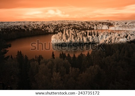 Landscape with a lake and forest in the summer evening in Finland. Filtered image: Shot with infrared filter.