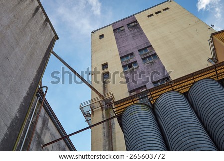 Concrete walls of factory exterior in Finland. This majestic old industrial building is not in use anymore. Very strong perspective and low angle view.