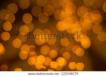 many defocused golden dots on a brown background