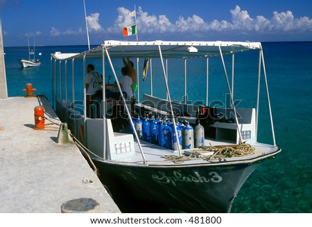 This Cozumel dive boat is preparing to load divers onboard for a day of sun,adventure,and scuba diving