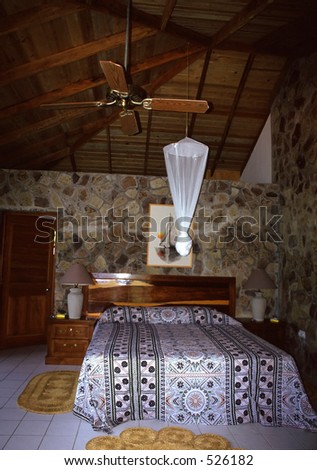 Interior shot of a Caribbean resort room complete with mosquito net