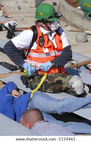 Community Emergency response person with victim in mock disaster