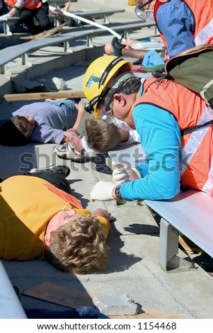 Rescue aide helps victim in this mock community disaster drill