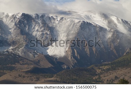 Sierra Nevada Mountains, CA, on the east side a blizzard is raging on the peaks./Sierra Nevada/ The foot hills are in sunshine and still in grass while the peaks are in a snow storm. Winter is coming