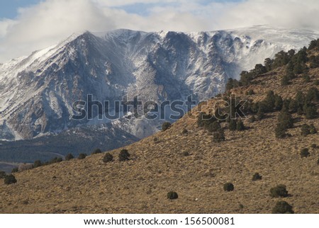 Sierra Nevada Mountains, CA, on the east side a blizzard is raging on the peaks./Sierra Nevada/ The foot hills are in sunshine and still in grass while the peaks are in a snow storm. Winter is coming