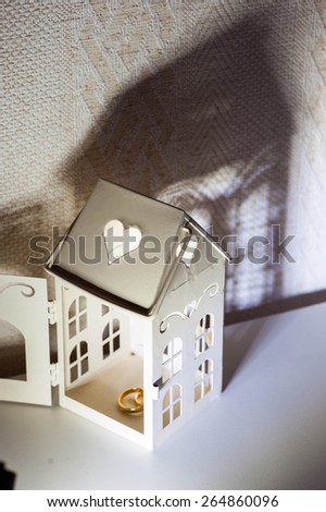small house and wedding rings