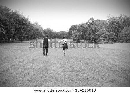 A couple holding hands in the park