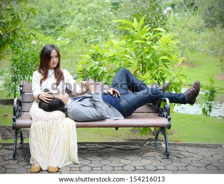 a man lying on a woman\'s lap