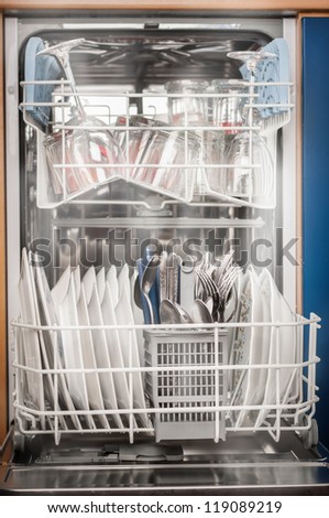 Clean dishes from dishwasher with hot steam around.