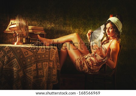 Attractive Cuban girl relaxing on hot day indoors