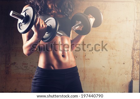 Fitness woman in training.Strong abs showing