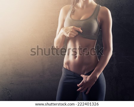 Fit woman showing her perfect abs