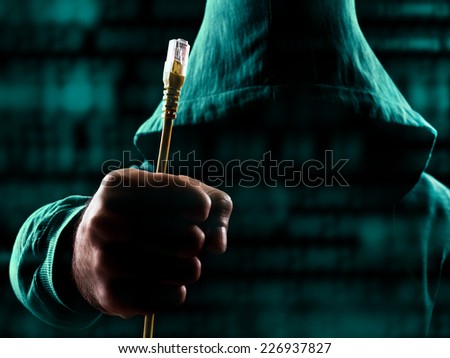 Suspicious man with hood holding unplugged internet cable surrounded with data