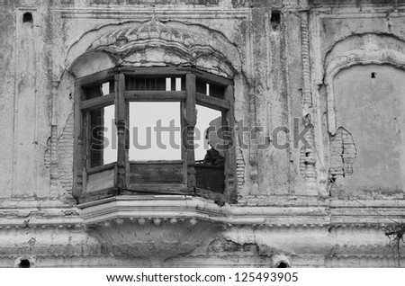 Wall detail with old destroyed window in abandoned Jammu Palace, Jammu & Kashmir, India - black & white picture