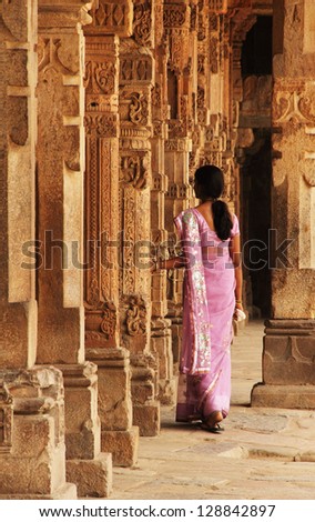DELHI/INDIA - JULY 21:Unidentified Indian woman goes through the gallery of Quwwat-ul-Islam Mosque on July 21, 2011 in Qutub Minar complex, Delhi, India. There are over four million visitors yearly.