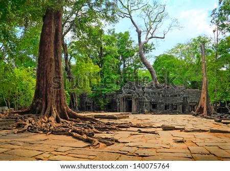 SIEM REAP/CAMBODIA - MAY 04. Scenic view of ancient square and huge tree root in front of destroyed Ta Prohm temple on may 04, 2013 in Angkor archeological complex, Cambodia.