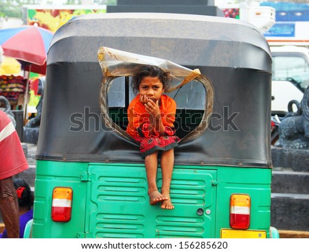 Jaffna, Sri Lanka - Aug 12: Young Girl Asha, 11, Sits In The Window Of Her Father\'S Traditional Taxi On August 12, 2013 In Jaffna, Sri Lanka, South Asia. Tuk-Tuk Is A Popular Asian Transport As Taxi.