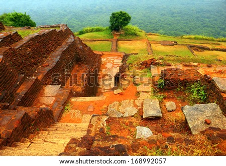 Beautiful scenic view - ancient ruined King Kassapa Palace in Sigiriya Fortress (Lion\'s Rock) - UNESCO World Heritage Site against the background of green wood, Sri Lanka island, South Asia
