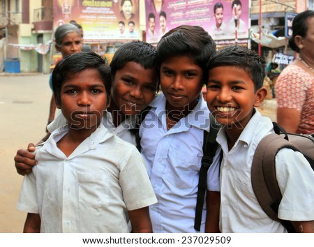 MADURAI, INDIA - AUG 14: Unidentified hindu school children dressed in uniform go home after classes on August 14, 2014 in Madurai, Tamil Nadu, Southern India