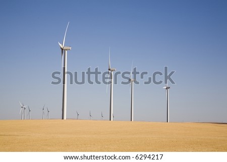 Electric wind turbines in the wheat fields