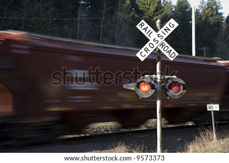 Rail road crossing lights with train in motion