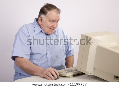 Old guy grinning at the computer