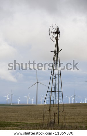 Old time windmill and the younger newer generation