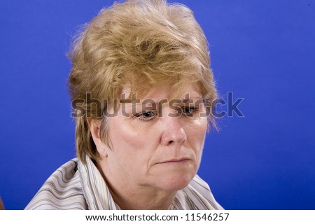 woman in a depressed state of mind on blue background