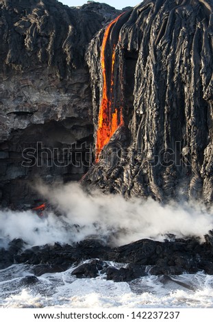 Red hot lava fall entering ocean, Big island, Hawaii