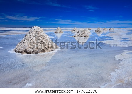Reflection of salt piles of Salar de Uyuni, giant salt flat in Bolovia, South America