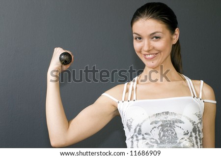Pump Iron - beautiful woman lifts the barbell